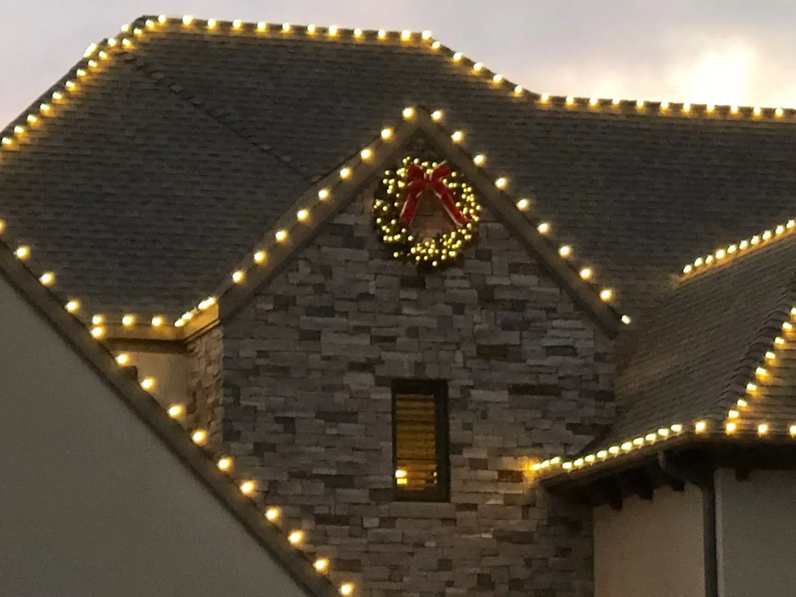 A close-up of warm-white commercial bulbs seated in clips along a Houston shingle line